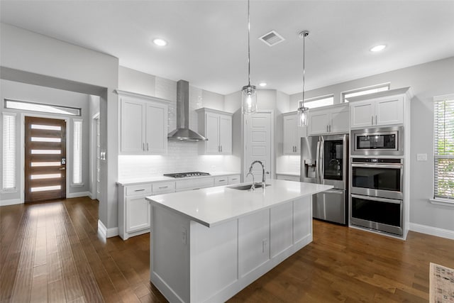2472 Bainbridge Dr, Allen, TX 75013 - kitchen with appliances with stainless steel finishes, wall chimney exhaust hood, a sink, baseboards, and light countertops