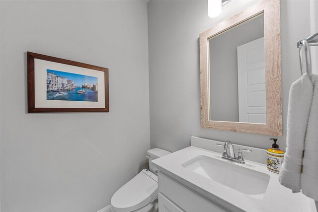 2472 Bainbridge Dr, Allen, TX 75013 - half bathroom featuring vanity and toilet