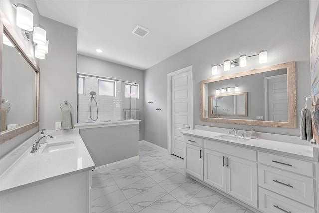 2472 Bainbridge Dr, Allen, TX 75013 - full bath with marble finish flooring, a walk in shower, two vanities, recessed lighting, and baseboards