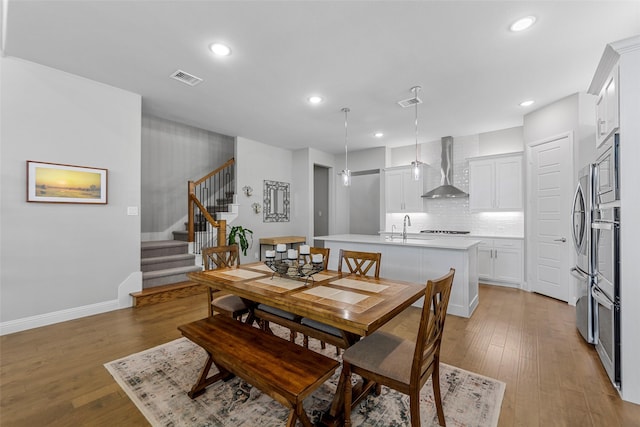 2472 Bainbridge Dr, Allen, TX 75013 - dining room with stairway, light wood finished floors, recessed lighting, and baseboards