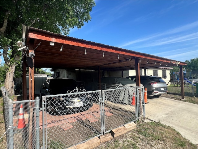 view of parking with a gate, fence, and a carport