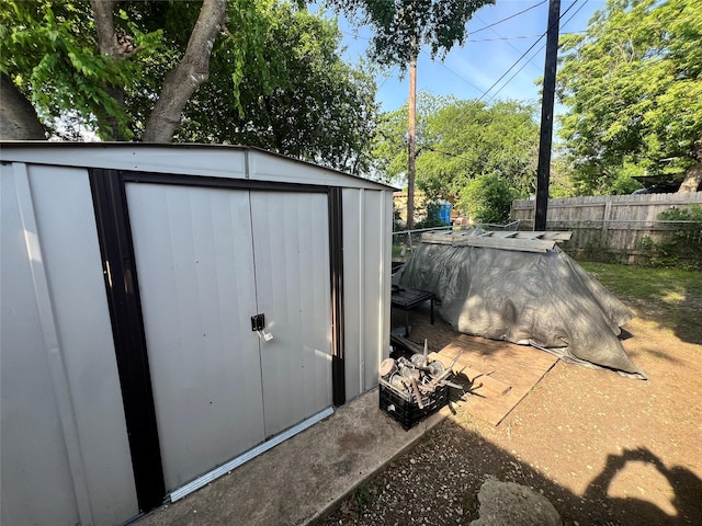 view of shed with fence