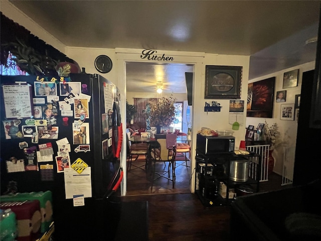 dining room featuring dark wood-style flooring and a ceiling fan
