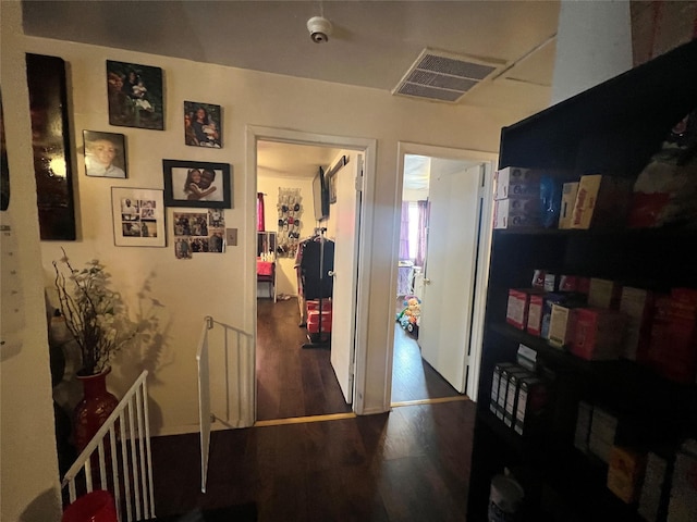 corridor featuring visible vents and wood finished floors