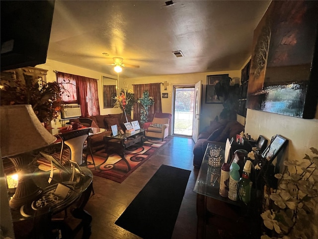 living room featuring a ceiling fan and visible vents