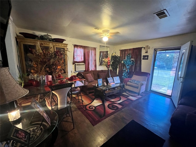living area featuring cooling unit, a ceiling fan, visible vents, and wood finished floors