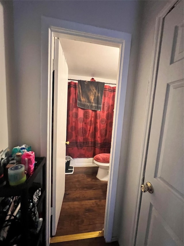 full bathroom with toilet, a shower with shower curtain, and wood finished floors