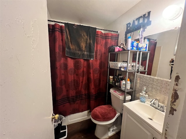bathroom with toilet, curtained shower, and vanity
