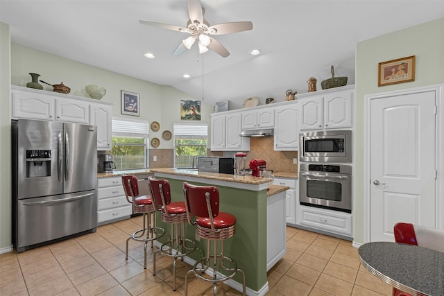 24 Tallwood Ln, Edgecliff Village, TX 76134 - kitchen featuring stainless steel appliances, light tile patterned floors, white cabinets, ceiling fan, and lofted ceiling