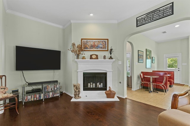 24 Tallwood Ln, Edgecliff Village, TX 76134 - living room featuring arched walkways, ornamental molding, wood finished floors, baseboards, and a fireplace with raised hearth