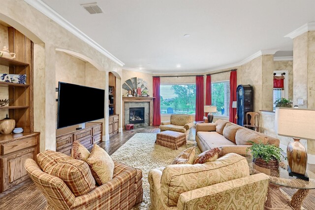 1421 Rolling, Celina, TX 75009 - living area featuring a fireplace, wood finished floors, baseboards, ornamental molding, and ornate columns
