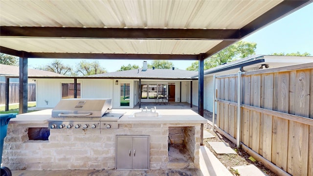 view of patio / terrace with area for grilling, a grill, and fence
