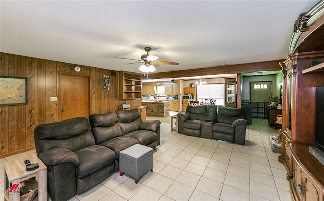 171 Columbia Road 84, Magnolia, AR 71753 - living room featuring wood walls, ceiling fan, a textured ceiling, and light tile patterned flooring