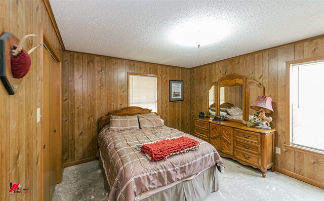 171 Columbia Road 84, Magnolia, AR 71753 - bedroom featuring wood walls, a textured ceiling, and baseboards