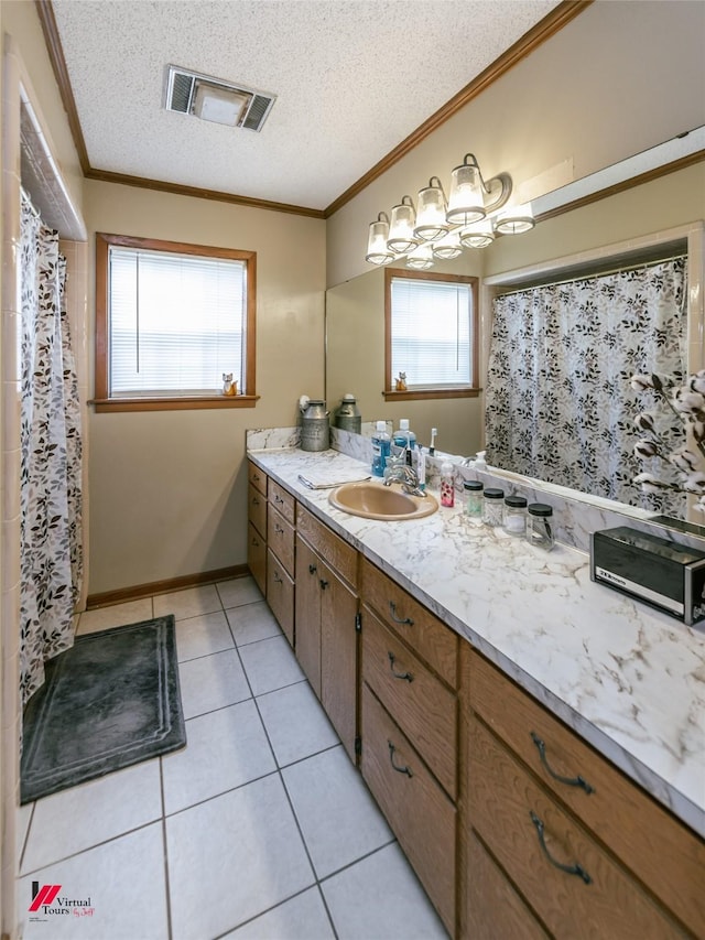 171 Columbia Road 84, Magnolia, AR 71753 - bathroom with plenty of natural light, ornamental molding, vanity, tile patterned floors, and a textured ceiling