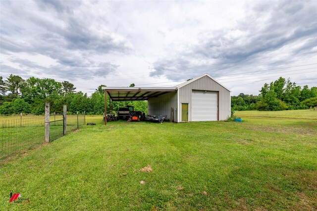 171 Columbia Road 84, Magnolia, AR 71753 - view of yard with a detached garage, an outdoor structure, and driveway