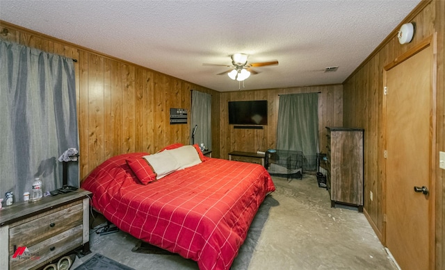 171 Columbia Road 84, Magnolia, AR 71753 - bedroom with wooden walls, concrete floors, a textured ceiling, and ceiling fan
