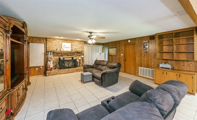 171 Columbia Road 84, Magnolia, AR 71753 - living area featuring wood walls, light tile patterned floors, ceiling fan, and a brick fireplace