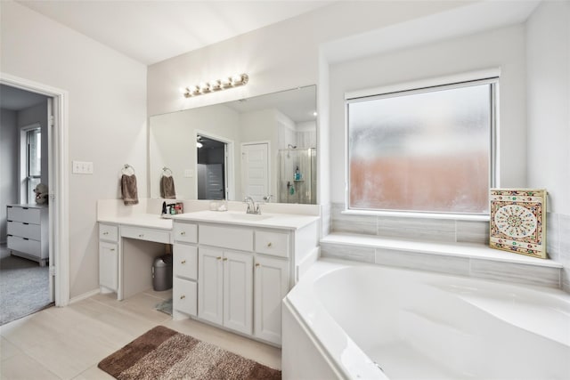 bathroom with a bath, vanity, and a shower stall