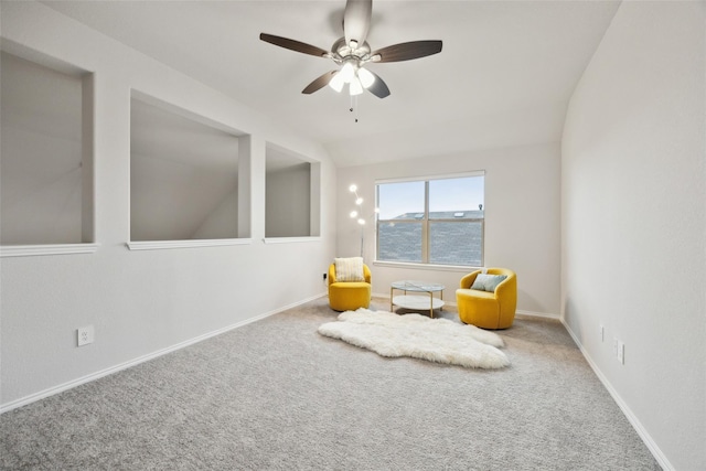sitting room with vaulted ceiling, baseboards, a ceiling fan, and carpet floors