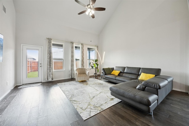 living area with wood finished floors, high vaulted ceiling, visible vents, a ceiling fan, and baseboards
