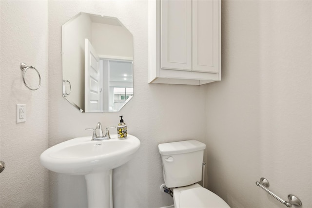 bathroom featuring toilet and a sink