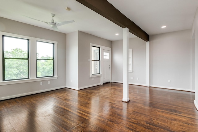 unfurnished living room featuring baseboards, a ceiling fan, plenty of natural light, and wood finished floors