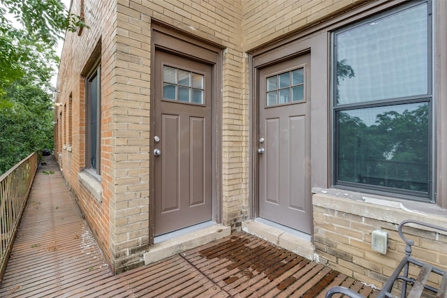 doorway to property featuring brick siding