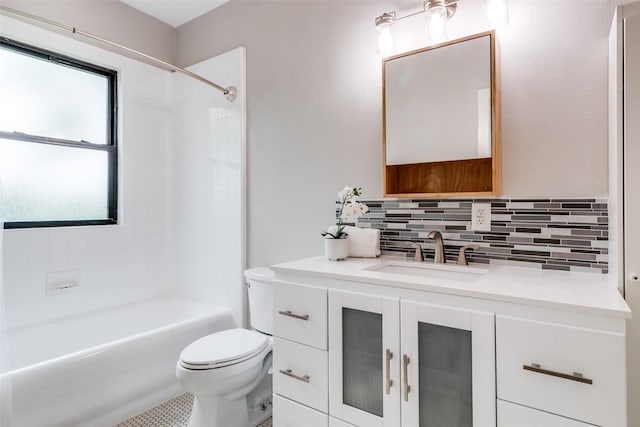 bathroom featuring backsplash, shower / bath combination, vanity, and toilet
