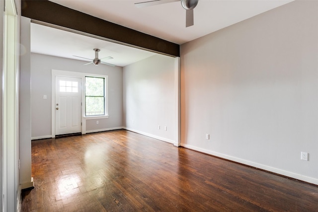 foyer entrance featuring a ceiling fan, dark wood-style flooring, baseboards, and beam ceiling