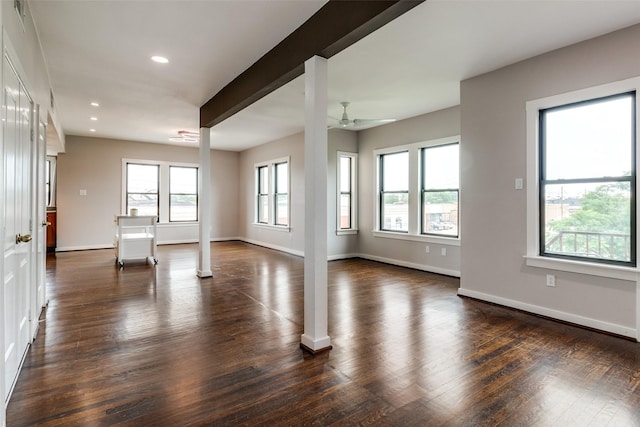 unfurnished living room with a ceiling fan, dark wood-style flooring, and baseboards