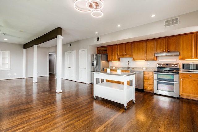 kitchen featuring under cabinet range hood, light countertops, visible vents, and appliances with stainless steel finishes