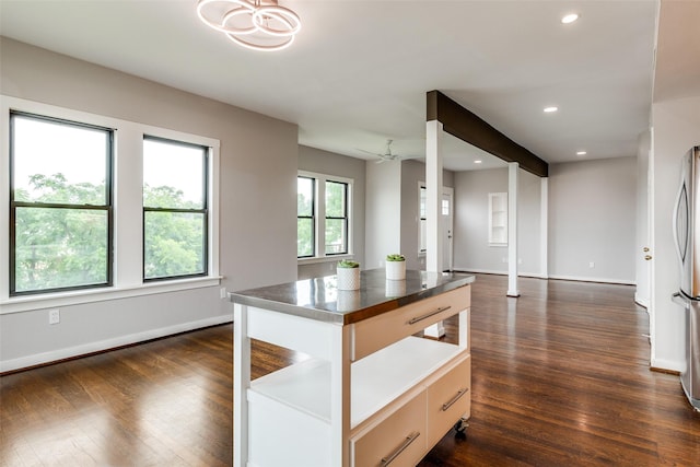 kitchen featuring freestanding refrigerator, dark countertops, baseboards, dark wood-style floors, and recessed lighting