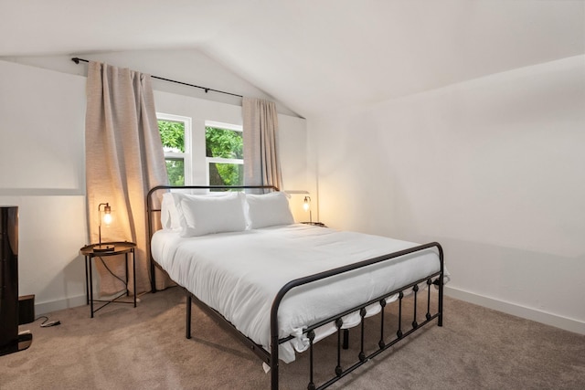 bedroom featuring carpet flooring, vaulted ceiling, and baseboards