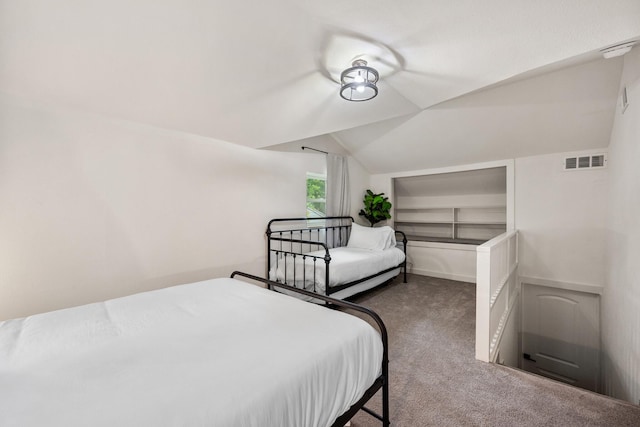 bedroom featuring vaulted ceiling, carpet flooring, baseboards, and visible vents