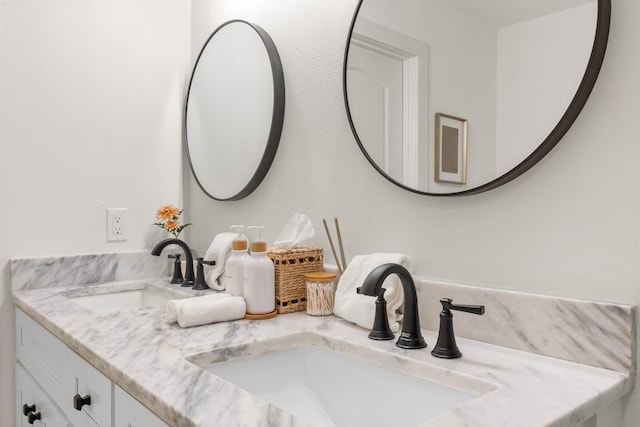 bathroom featuring double vanity and a sink
