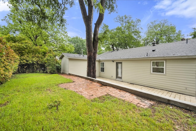 rear view of property featuring a yard and a patio
