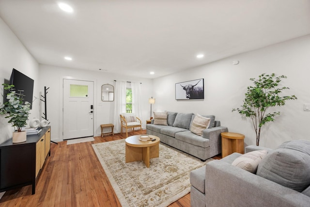 living room featuring light wood finished floors and recessed lighting