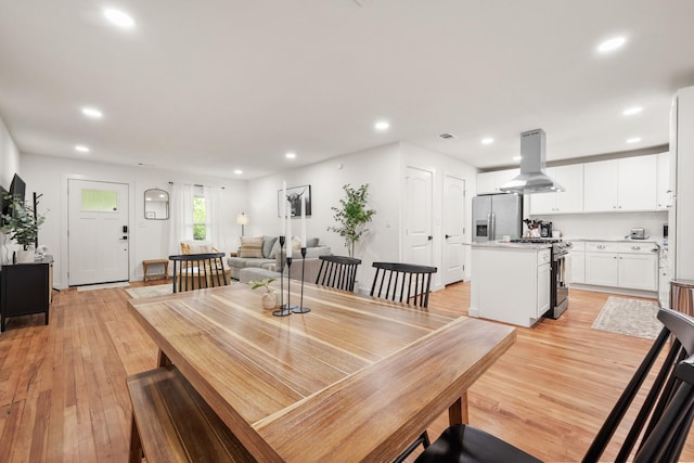 dining area featuring light wood finished floors, visible vents, and recessed lighting