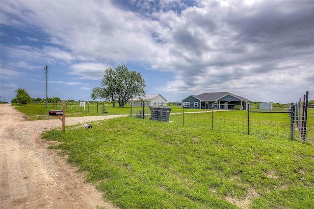 view of yard featuring a rural view and fence