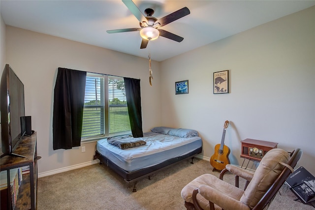 carpeted bedroom with baseboards and a ceiling fan