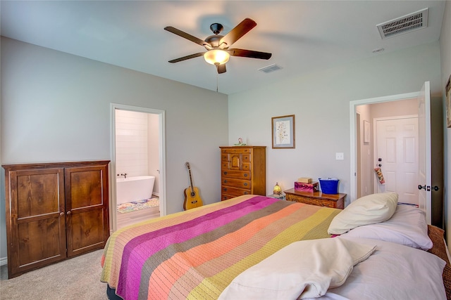 bedroom featuring connected bathroom, visible vents, ceiling fan, and light carpet