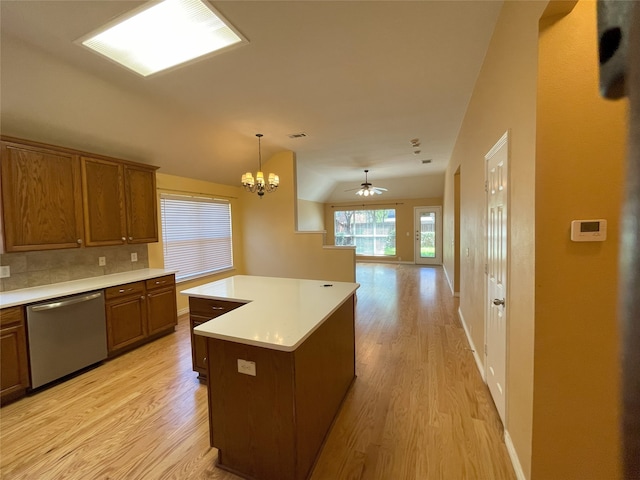 kitchen with brown cabinetry, dishwasher, light wood finished floors, open floor plan, and light countertops