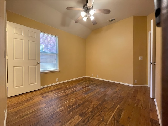 unfurnished bedroom featuring lofted ceiling, baseboards, visible vents, and dark wood-type flooring