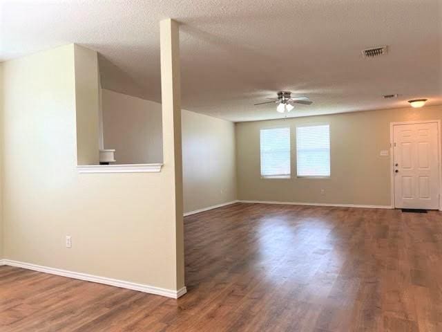 714 Kinston Ct, Wylie, TX 75098 - empty room featuring wood finished floors, visible vents, baseboards, and ceiling fan