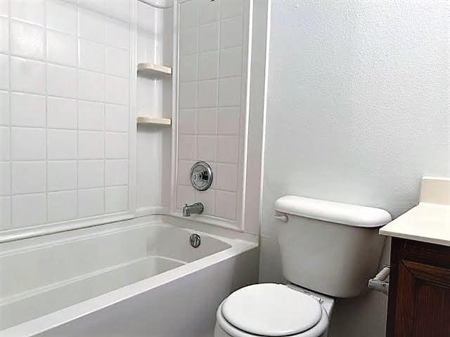 714 Kinston Ct, Wylie, TX 75098 - bathroom with shower / bathing tub combination, vanity, and toilet