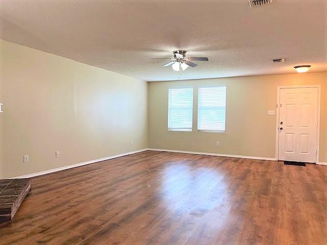 714 Kinston Ct, Wylie, TX 75098 - empty room featuring baseboards, dark wood-style flooring, visible vents, and ceiling fan