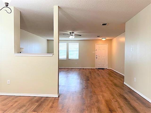 714 Kinston Ct, Wylie, TX 75098 - spare room with baseboards, visible vents, ceiling fan, and wood finished floors