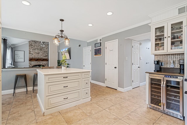 kitchen featuring wine cooler, recessed lighting, glass insert cabinets, visible vents, and cream cabinets