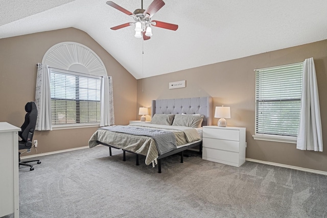 carpeted bedroom with baseboards, lofted ceiling, and ceiling fan